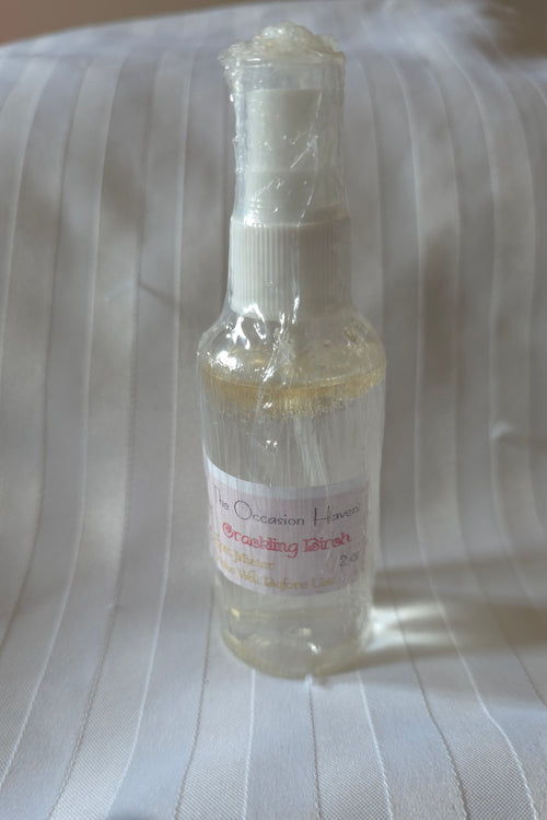 Small 2oz. bottle with a label on a textured white background