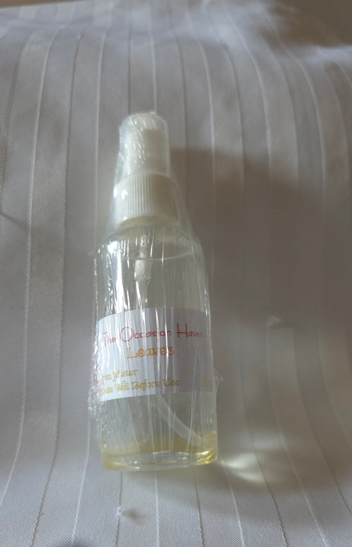 Clear 2oz. bottle with a label on a textured surface